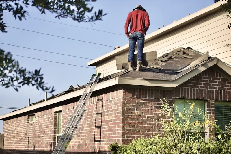 Professional roofer working on a residential roof in Salona Village